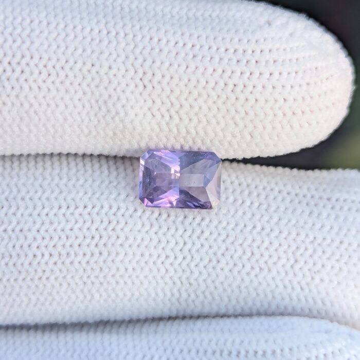 Purple sapphire on white fabric