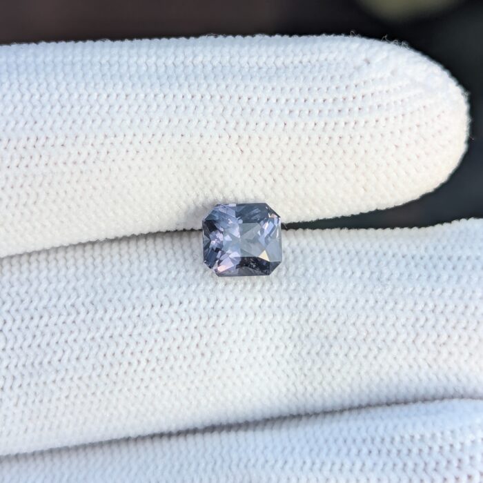 Grey spinal gemstone on white glove