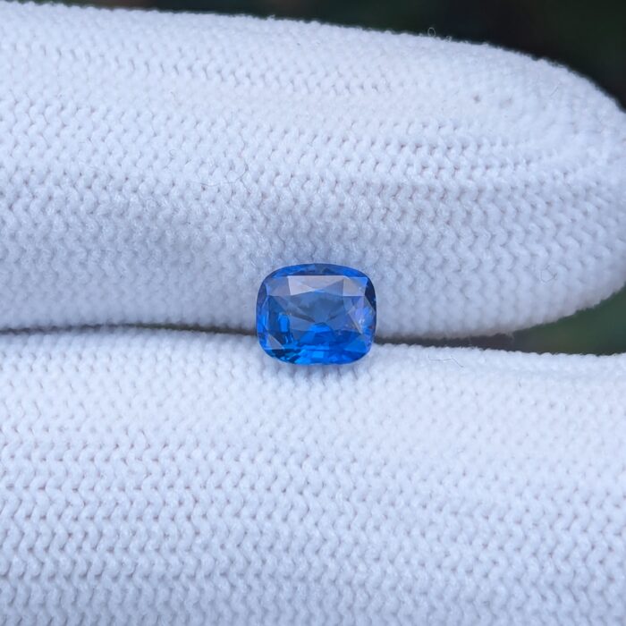 Brilliant blue sapphire gemstone on fabric